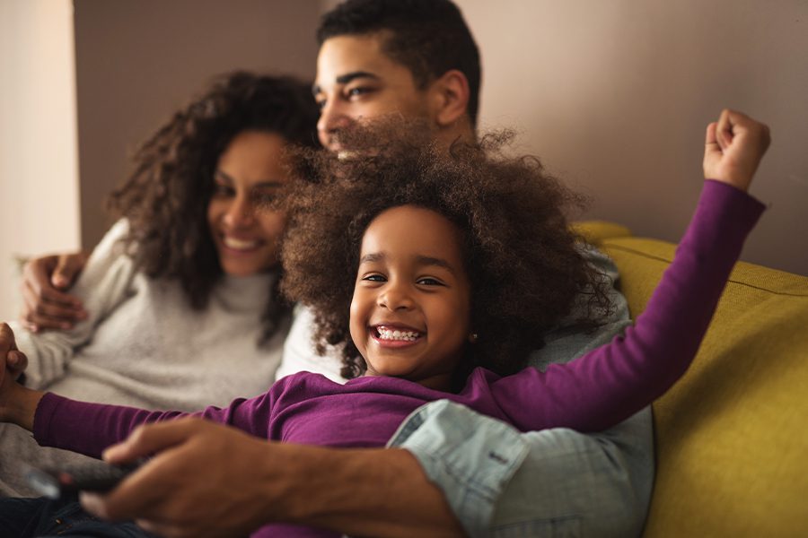 Blog - Happy Family Sitting on the Sofa in the Living Room